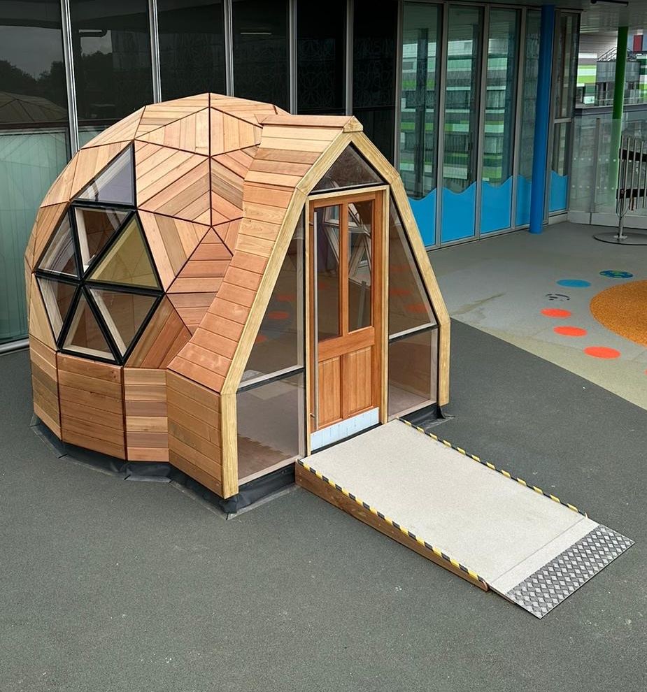 Cedar cladding and geometric window cut-outs on the pod
