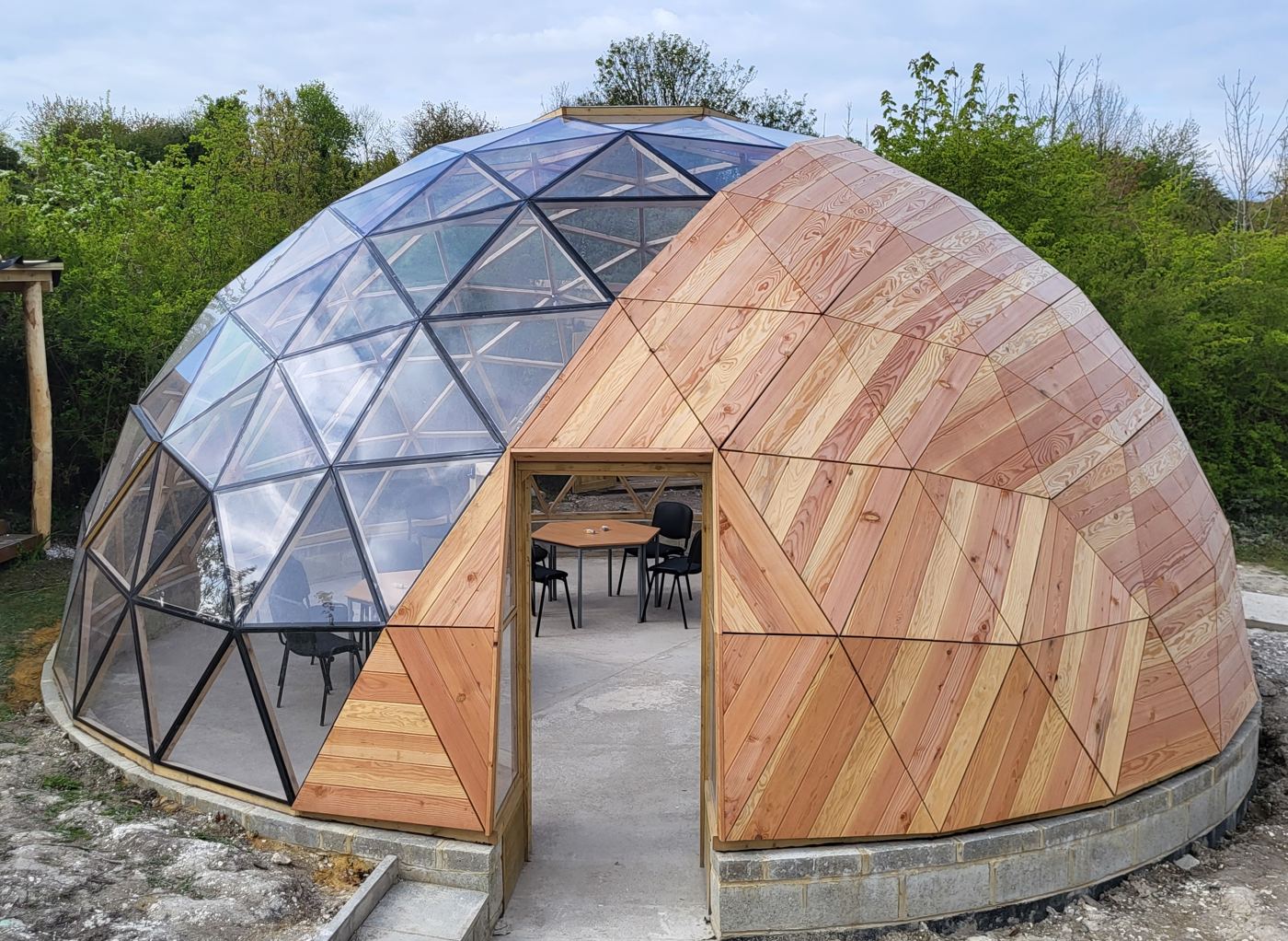 The dome with classroom tables set inside, seen through the open entrance